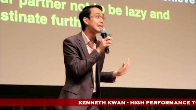 Kenneth Kwan speaking on stage at the NTUC Conference