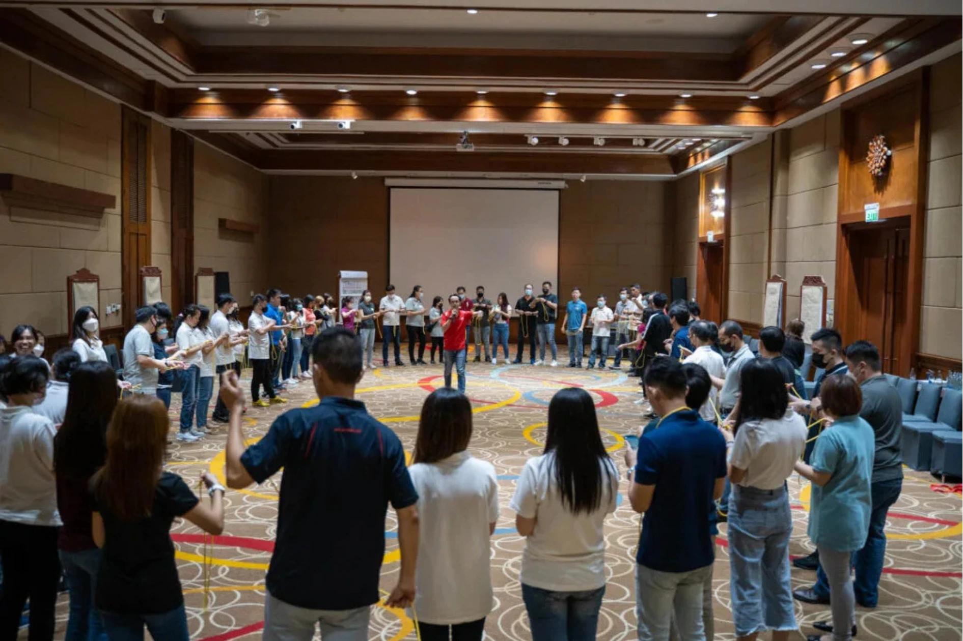 Large team participating in a behaviour change exercise to embed a change framework