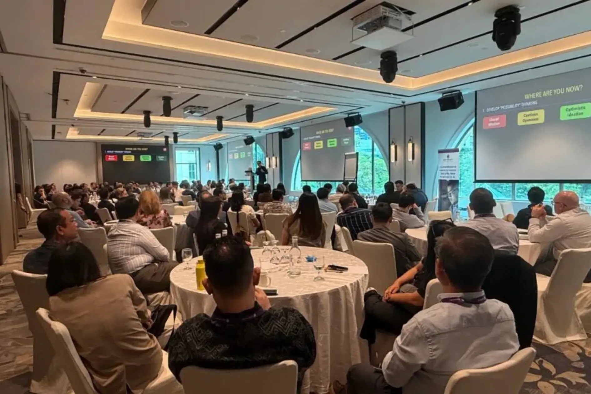 Corporate audience listening to a business keynote speaker about performance and culture