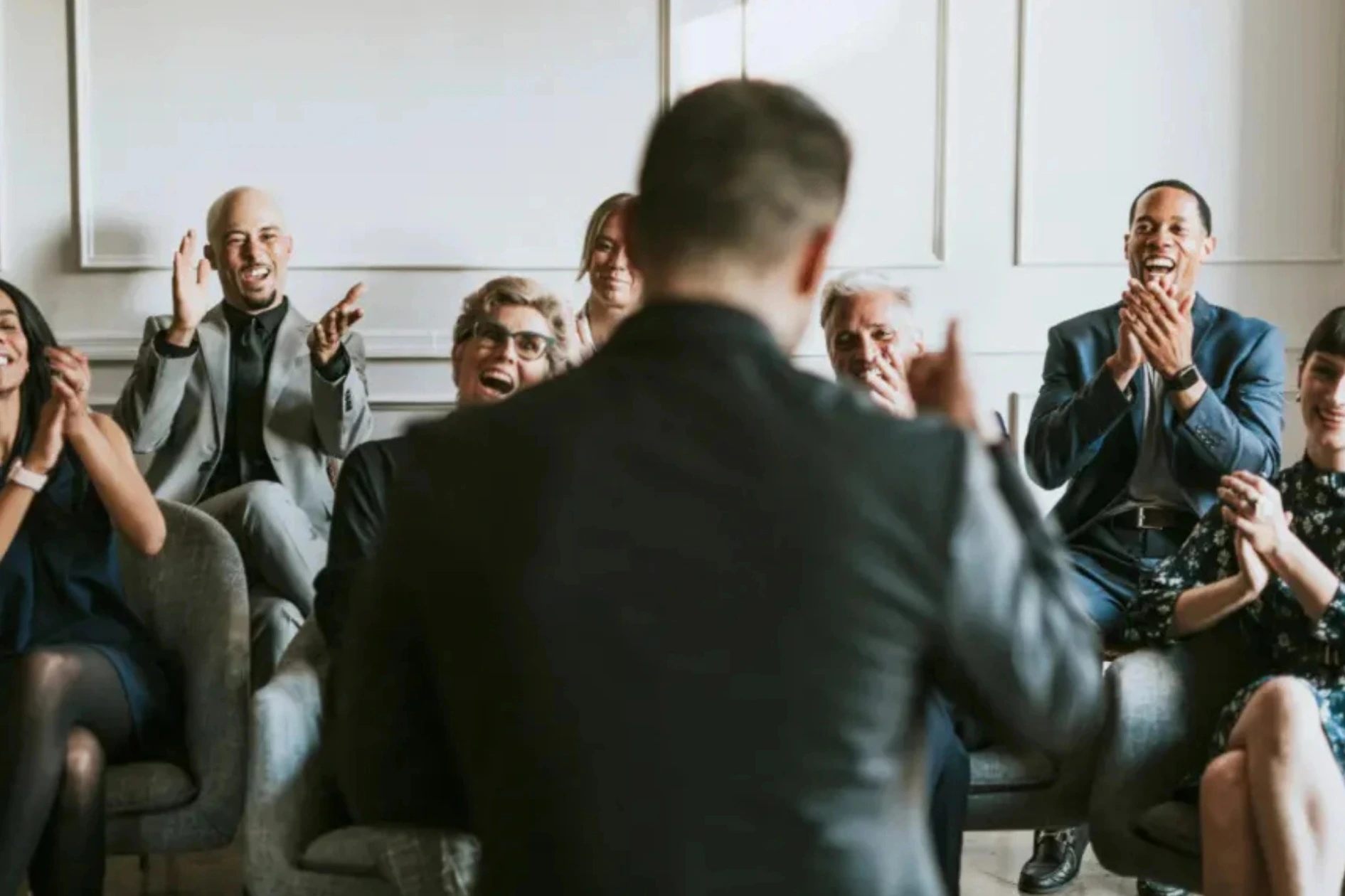 Audience applauding a leadership development speaker in Singapore